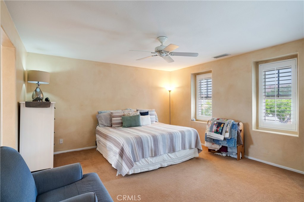 56 Freeland Irvine, CA 92602 - Photo 18 of 28 a bedroom with a bed a couch and a chandelier