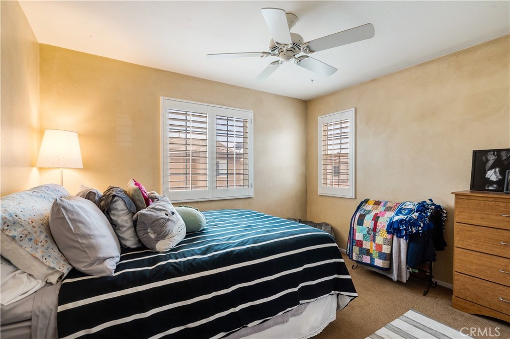 56 Freeland Irvine, CA 92602 - Photo 23 of 28 a bedroom with a bed and a chandelier