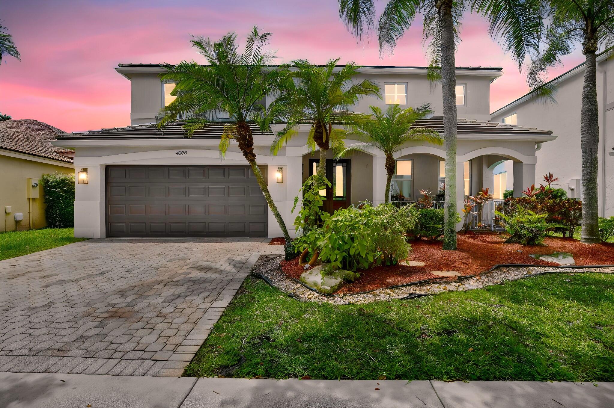 4299 Laurel Ridge Circle Weston, FL 33331 - Photo 15 of 103 a front view of a house with a yard and potted plants