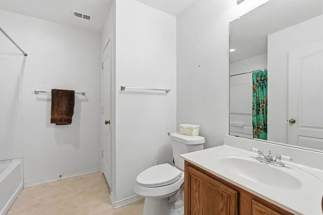 a bathroom with a sink toilet and mirror