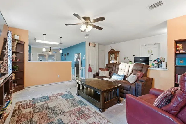 a living room with furniture and a flat screen tv