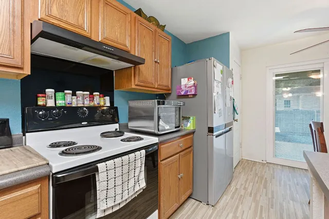 a kitchen with stainless steel appliances granite countertop a stove and a refrigerator