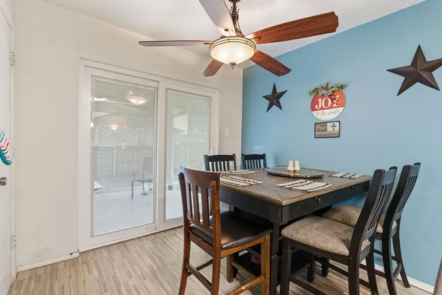 a view of a dining room with a table and chairs