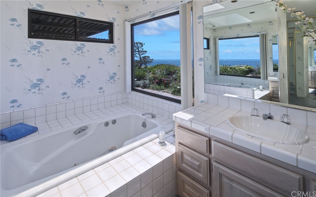 23741 Perth Bay Dana Point, CA 92629 - Photo 8 of 25 a bathroom with a tub sink and mirror