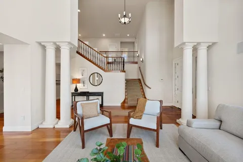 a view of a livingroom with furniture and hardwood floor