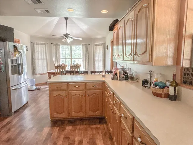 a kitchen with stainless steel appliances a sink a stove a refrigerator and cabinets