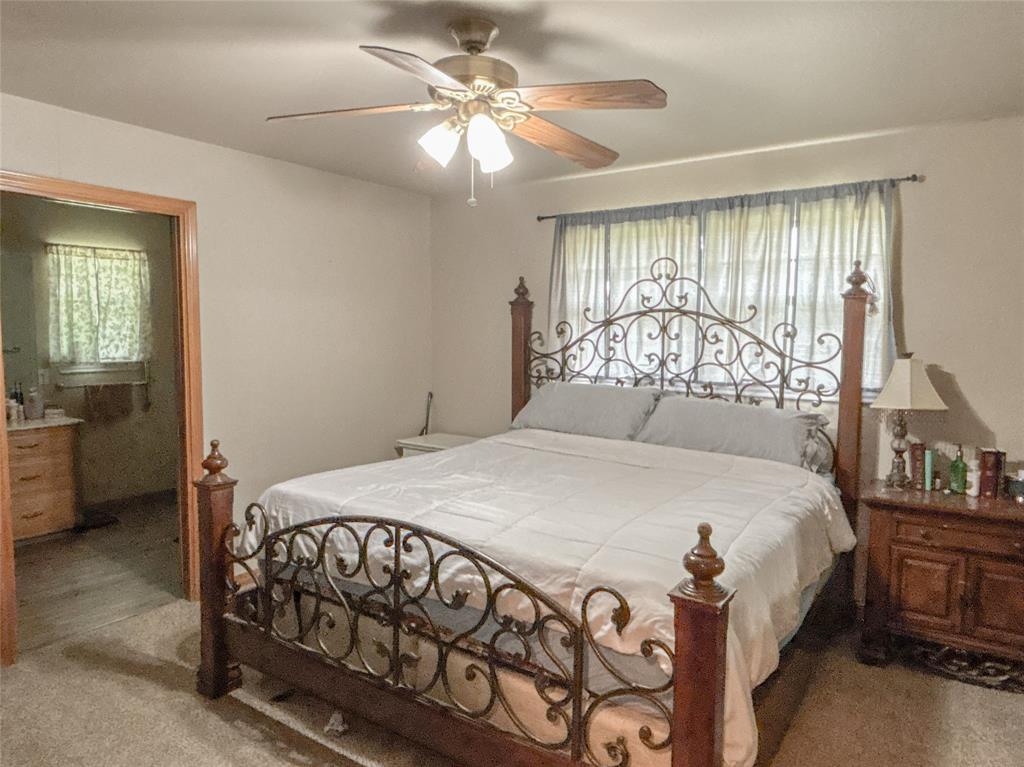 7526 Fm 2114 Road Hubbard, TX 76648 - Photo 15 of 40 a bedroom with a bed and a chandelier