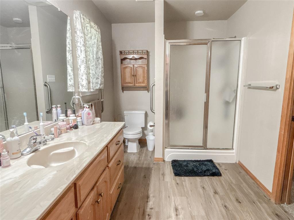 7526 Fm 2114 Road Hubbard, TX 76648 - Photo 16 of 40 a bathroom with a double vanity sink a mirror and shower