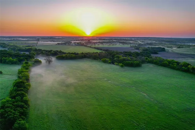a view of lake with sunset