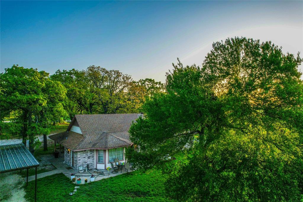 7526 Fm 2114 Road Hubbard, TX 76648 - Photo 23 of 40 a view of a house with a big yard potted plants and large tree