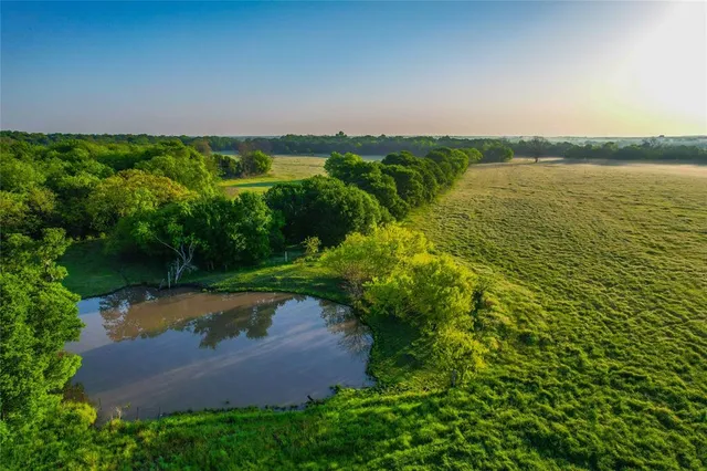 an aerial view of a houses with yard