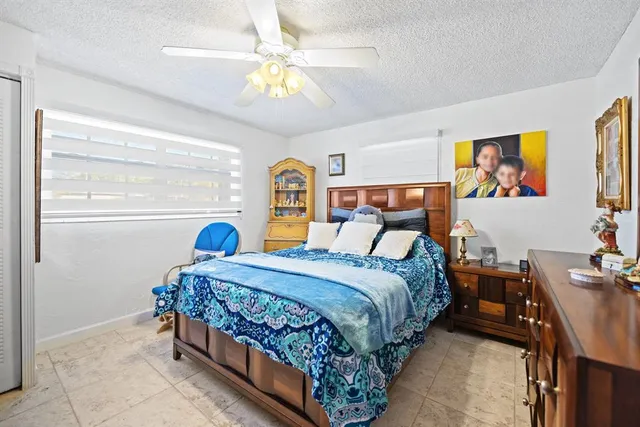 a bedroom with a bed and painting on the wall