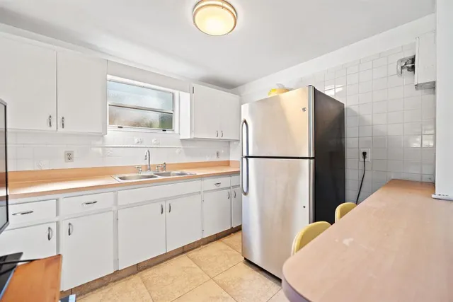 a kitchen with sink cabinets and refrigerator