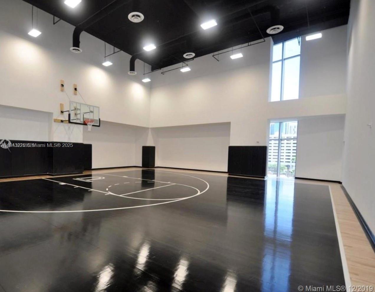 851 Northeast 1st Avenue, Unit 903 Miami, FL 33132 - Photo 31 of 34 a room with lots of potted plants and wooden floor