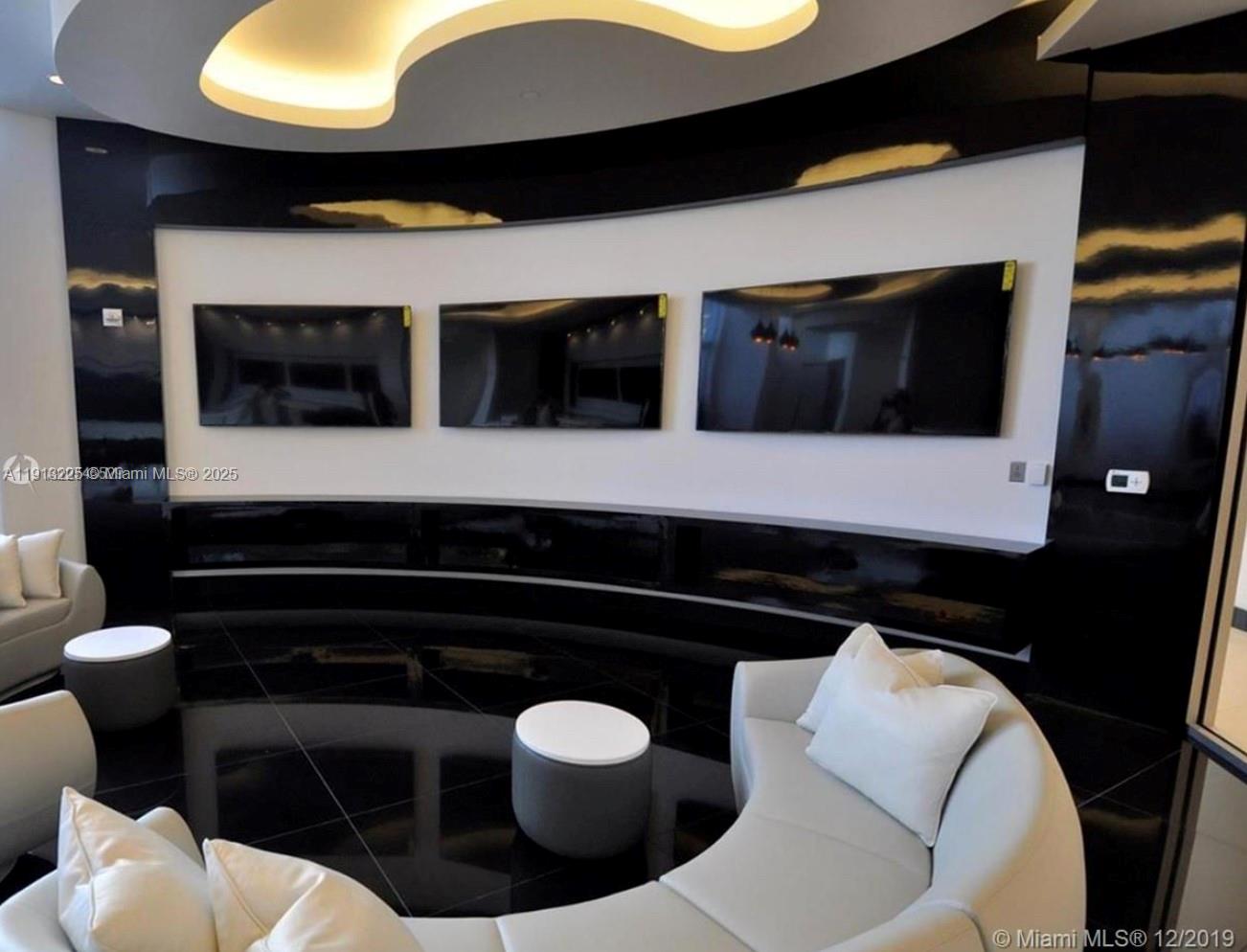 851 Northeast 1st Avenue, Unit 903 Miami, FL 33132 - Photo 33 of 34 a living room with furniture and a flat screen tv