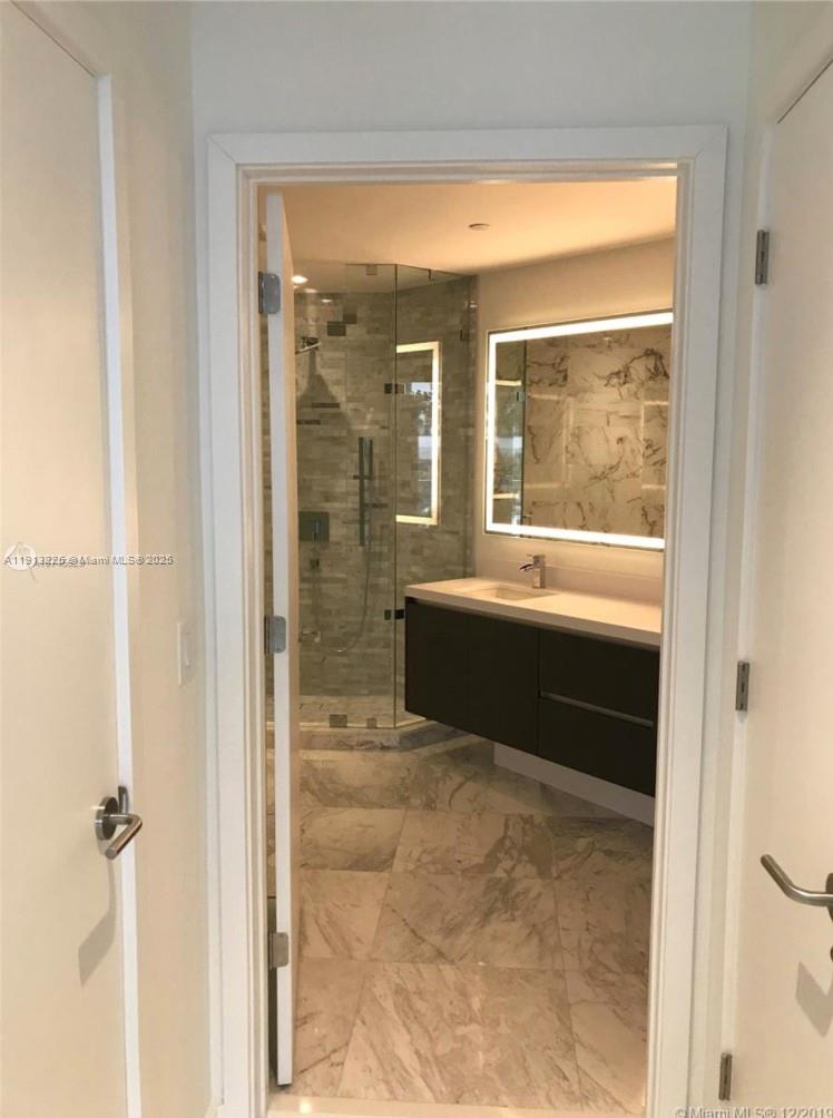 851 Northeast 1st Avenue, Unit 903 Miami, FL 33132 - Photo 5 of 34 a bathroom with a tub sink shower and mirror