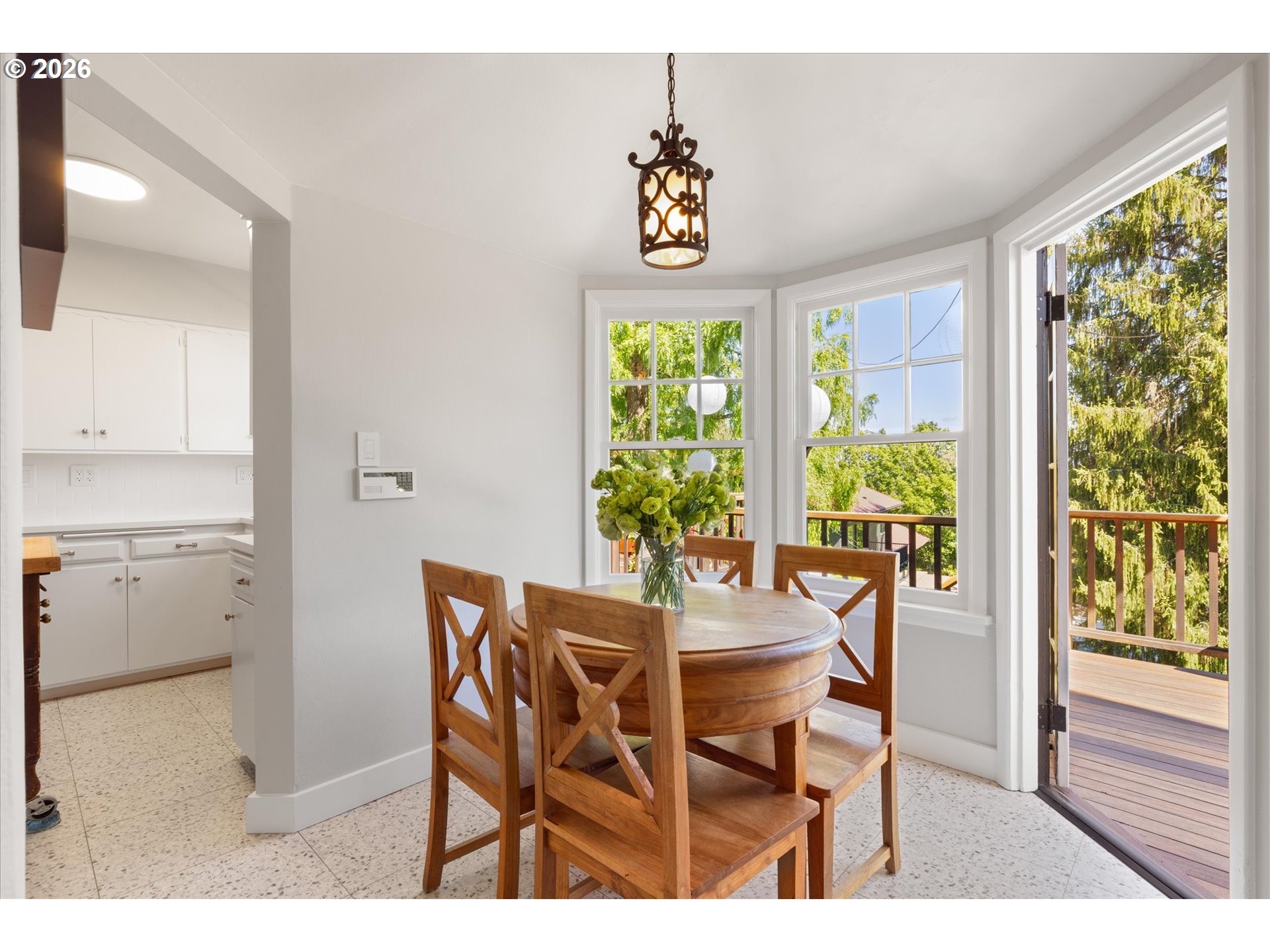 2939 Northwest Cornell Road Portland, OR 97210 - Photo 13 of 42 a dining room with furniture a rug and a potted plant