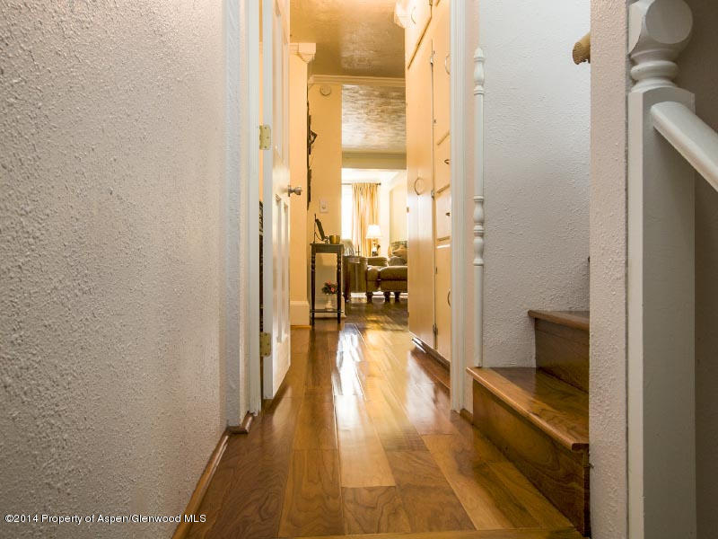 150 Clarkson Avenue Rifle, CO 81650 - Photo 8 of 27 a view of a hallway with wooden floor and furniture