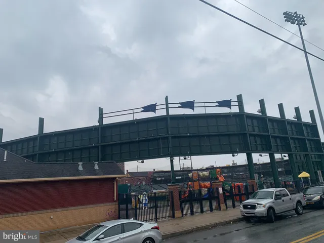 a view of a patio with table and chairs under an umbrella