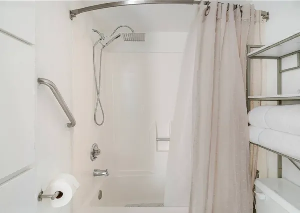 a bathroom with a shower and a shower