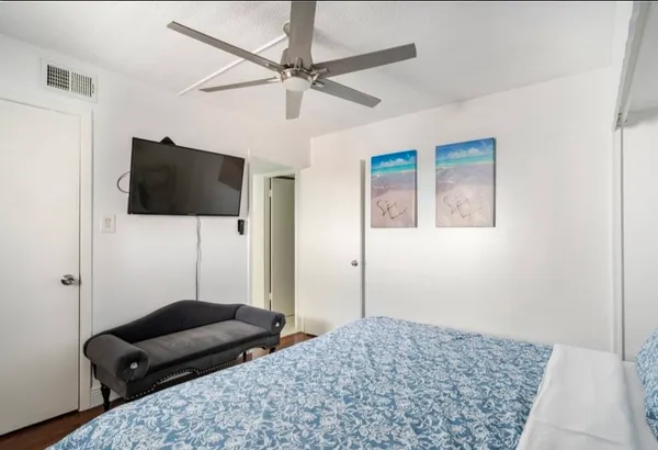 a bedroom with a bed and a flat screen tv