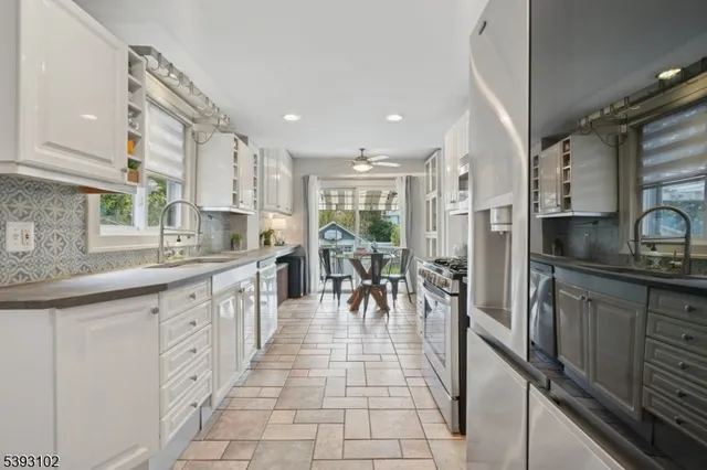 a large kitchen with lots of counter top space and stainless steel appliances