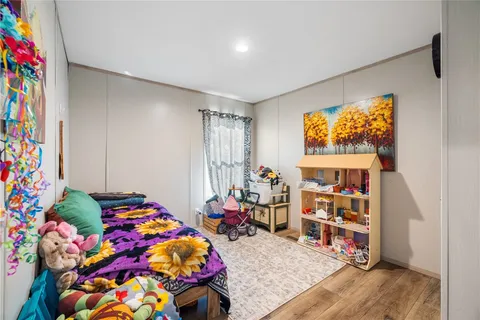 a bedroom with furniture and a wooden floor