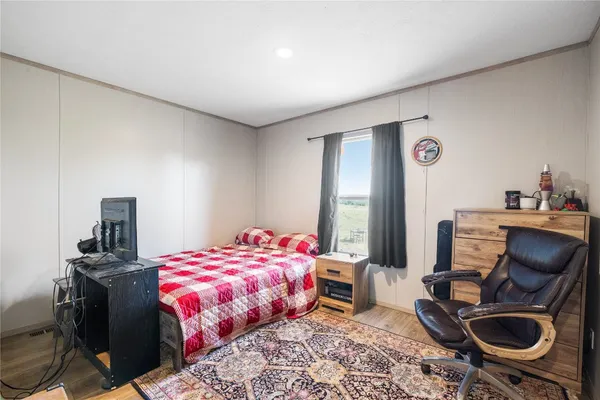 a bedroom with a bed and a chair