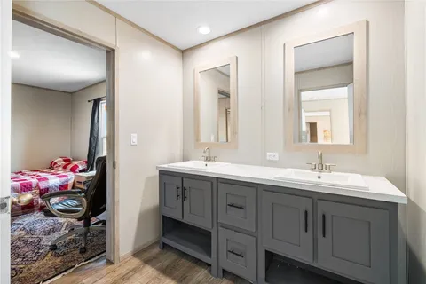 a bathroom with a double vanity sink mirror and