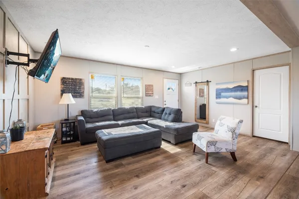 a living room with furniture and a large window
