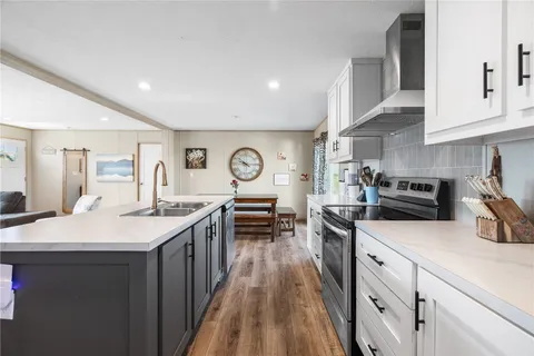 a kitchen with sink stove and cabinets