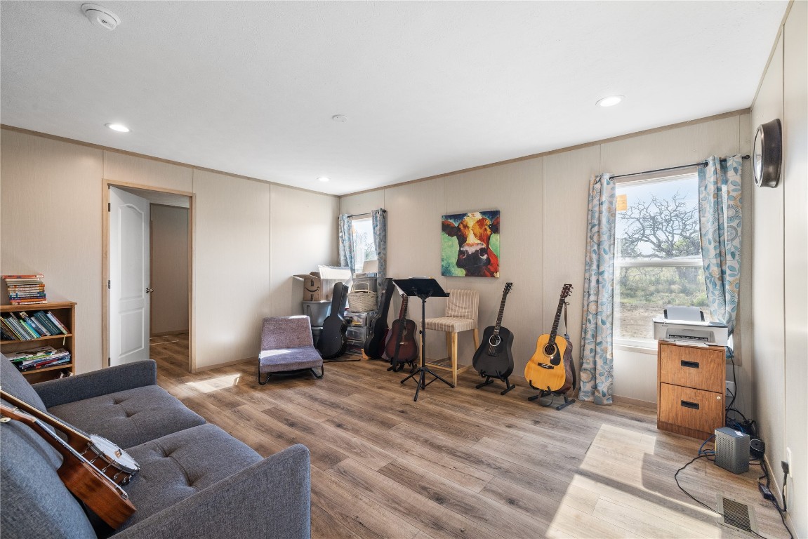 245 Sky Trail Harper, TX 78631 - Photo 7 of 16 a room with furniture a window and gym equipment