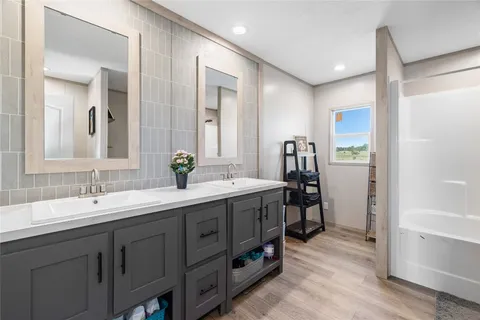 a bathroom with a double vanity sink and a mirror