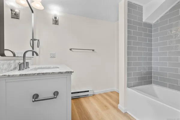 a bathroom with a granite countertop sink and a mirror