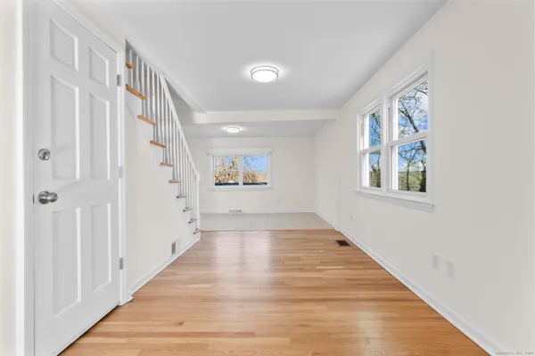 a view of an entryway with wooden floor