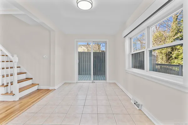an empty room with staircase and white walls
