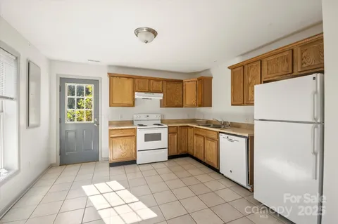 a view of a kitchen with white cabinets