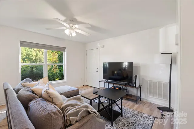 a kitchen with a refrigerator a stove top oven a counter space and a window