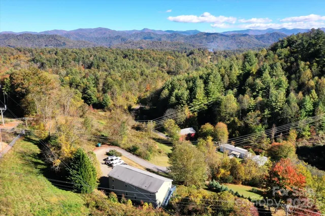 a aerial view of a house with yard and lake view