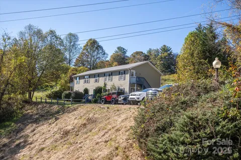 a view of a big room with wooden floor and windows