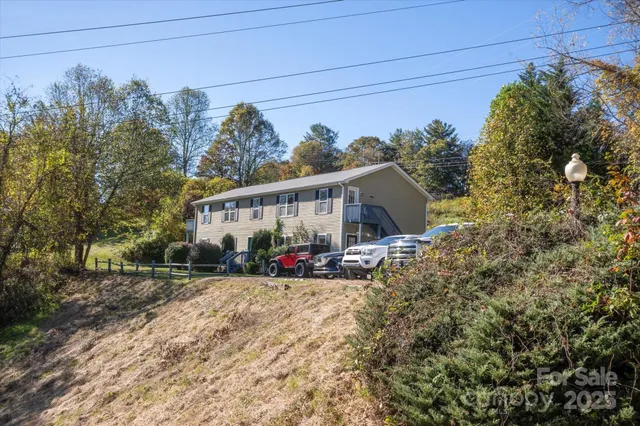 a view of a big room with wooden floor and windows