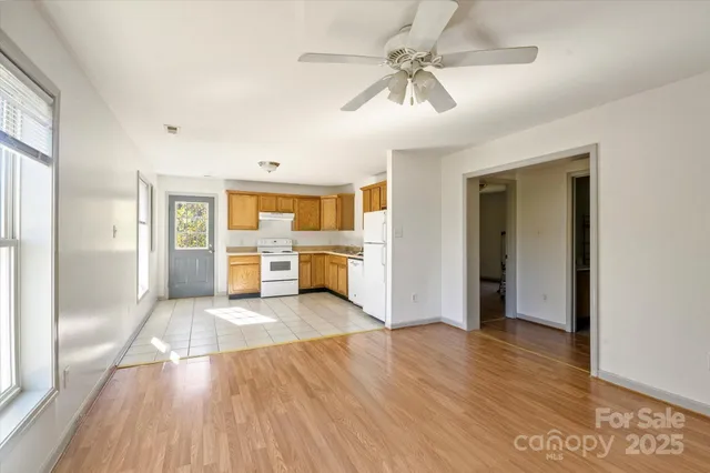a kitchen with a refrigerator a stove top oven and a sink