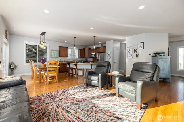 a living room with lots of furniture and kitchen view