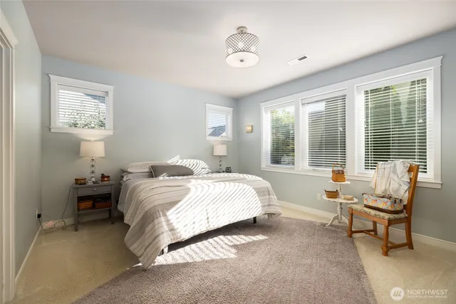 a spacious bedroom with a bed and a window