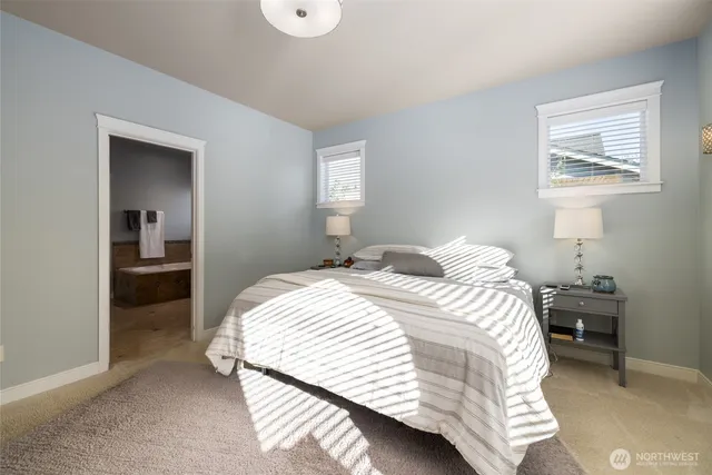 a bedroom with a bed and a painting on the wall