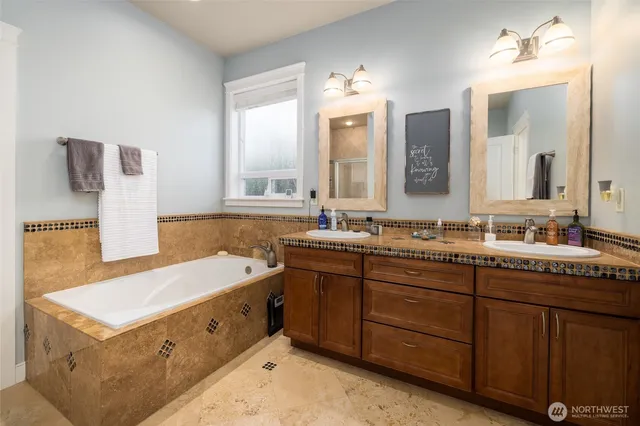 a spacious bathroom with a double vanity sink mirror and double