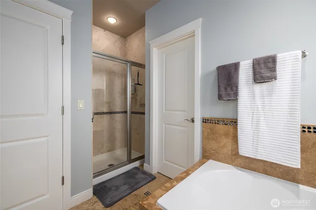 a bathroom with a shower and closet