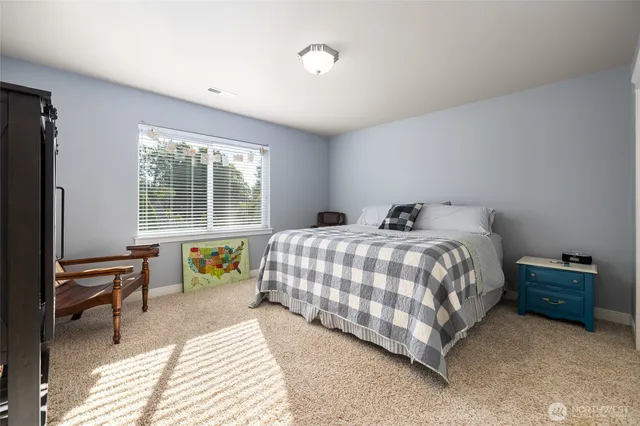 a bedroom with a bed and a desk