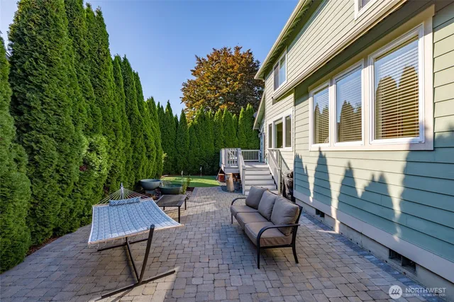 a view of a patio with table and chairs with wooden floor and plants