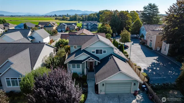 an aerial view of a house with a big yard and large trees